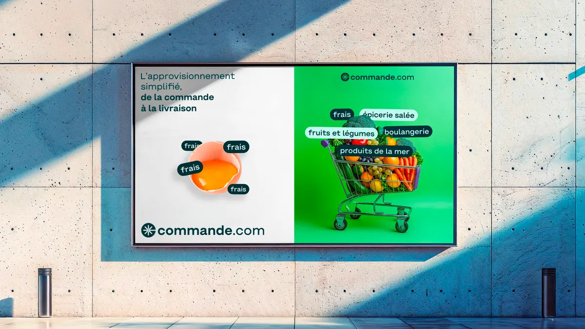 Affiche Commande.com sur un mur en béton, chariot de courses et rubriques de produits frais