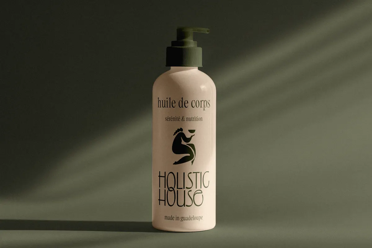 Flacon d'huile de corps crème à l'étiquette Holistic House
