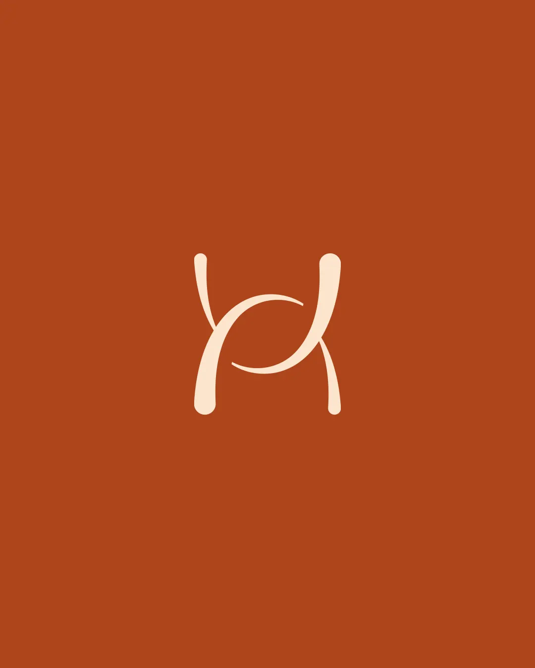 Monogramme entrelacé de Holistic House, crème sur fond terre cuite